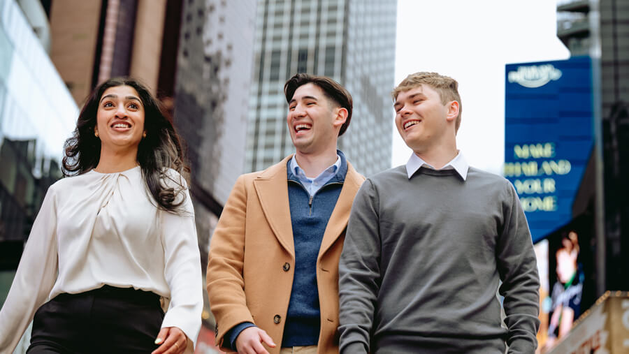 Three Quinnipiac students walking in Times Square.