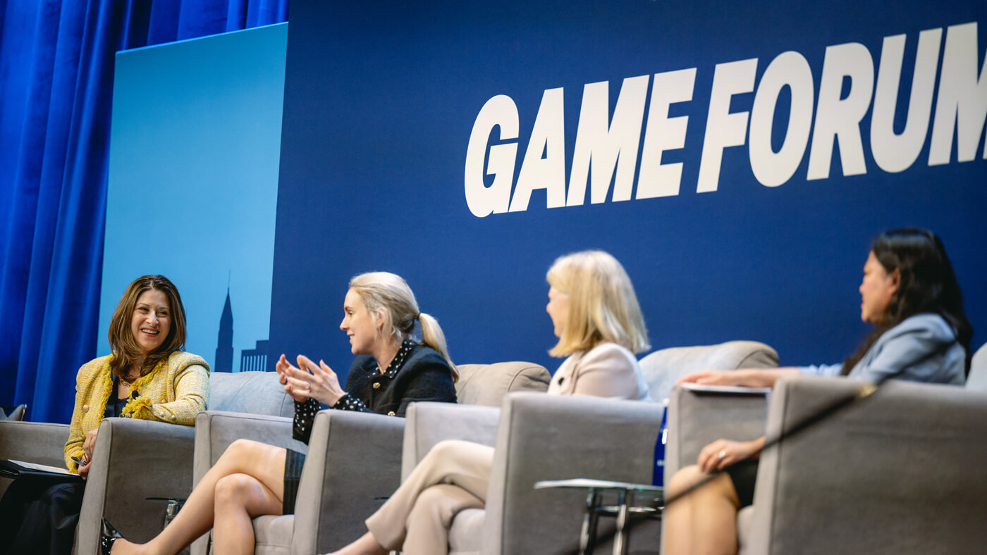 Dean Holly Raider moderates a panel of female executives on the GAME Forum stage.