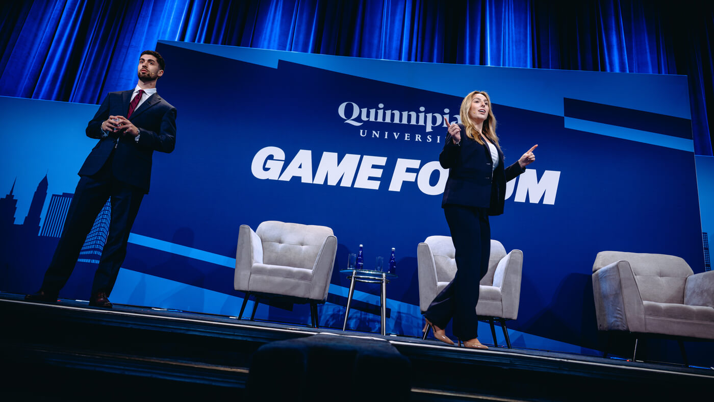 Two Quinnipiac students emcee the 2025 GAME Forum.
