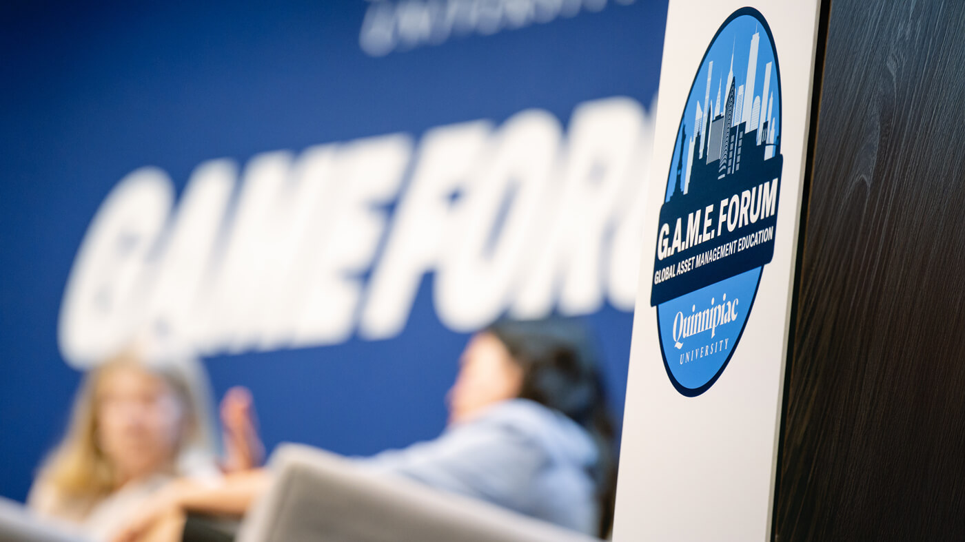 2025 GAME Forum logo with panelists discussing in the background.