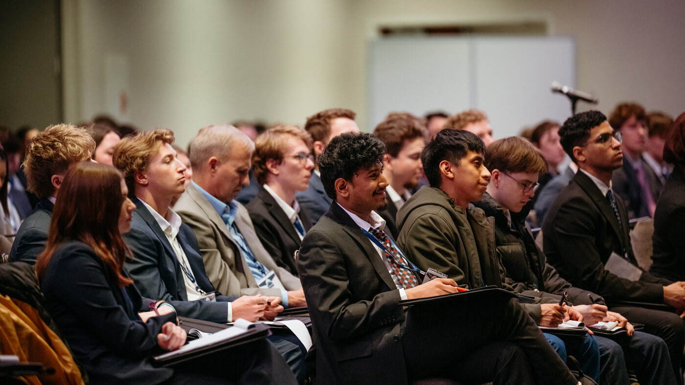 Students and guests seated in rows listen closely during a GAME Forum panel presentation.