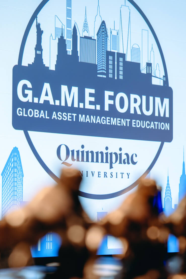 GAME Forum 2025 logo on a screen with awards out of focus in the foreground.