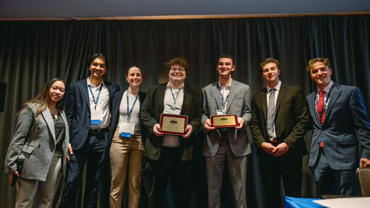 Awardees representing the Undergraduate Value category stand on stage with their certificate at the GAME Forum Poster Competition.
