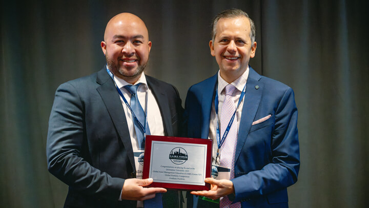 Student participants' professors in the Graduate Overall category gather on stage with their award at the GAME Forum Awards Ceremony.