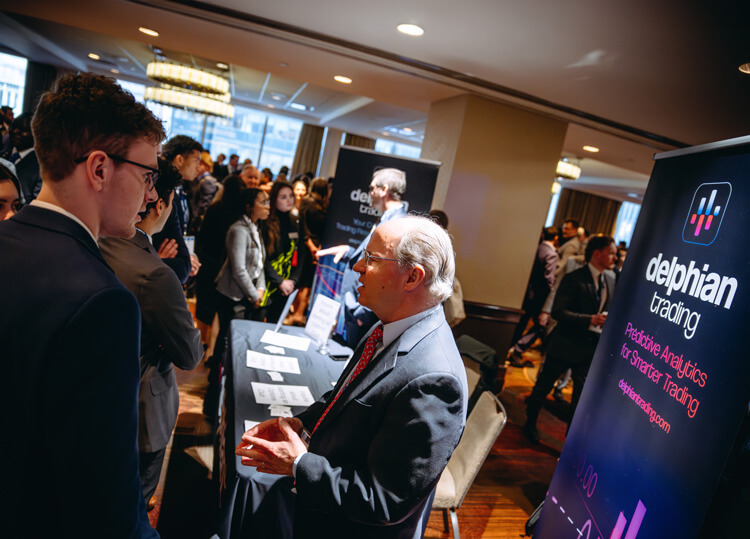 Students networking with representatives from Delphian Trading at GAME Forum XIII.